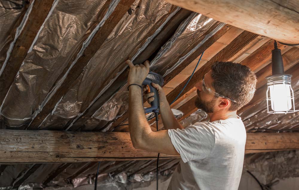 Man installing home insulation